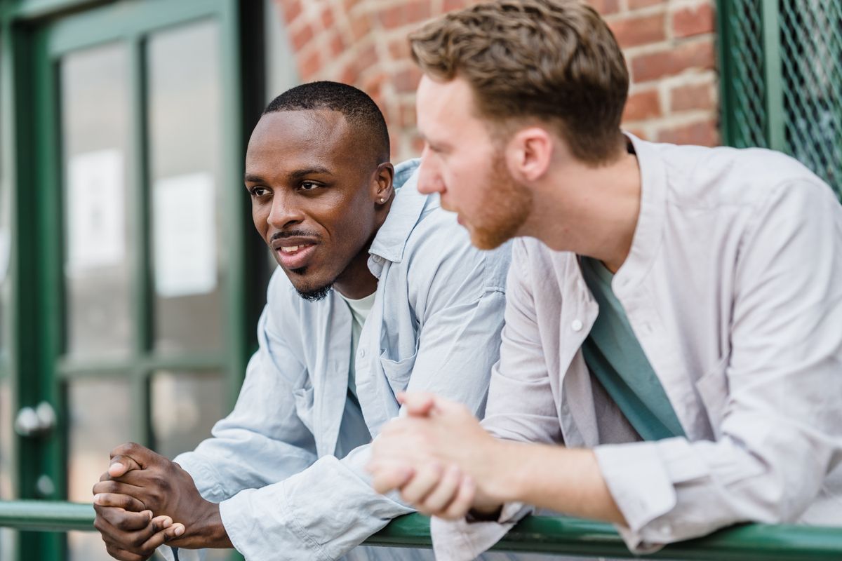 Two young people in conversation outdoors.