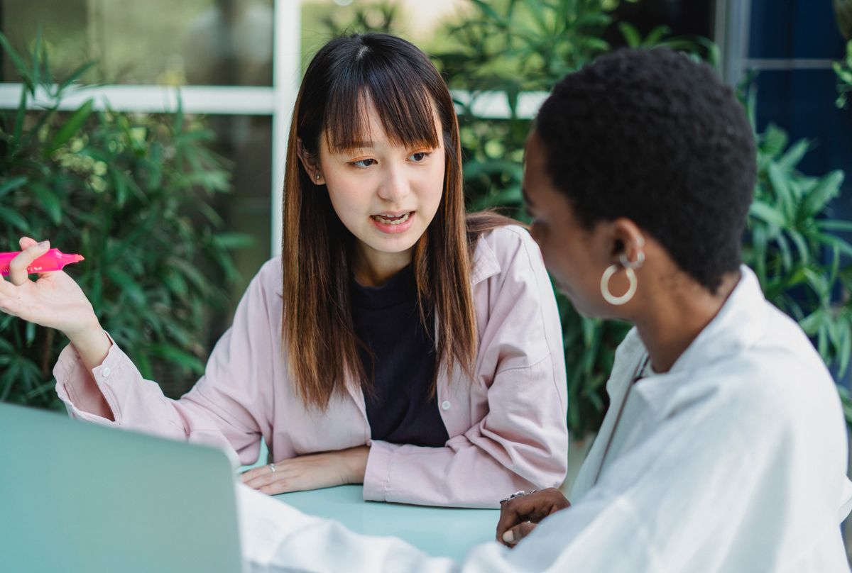 Two people collaborating at a laptop.