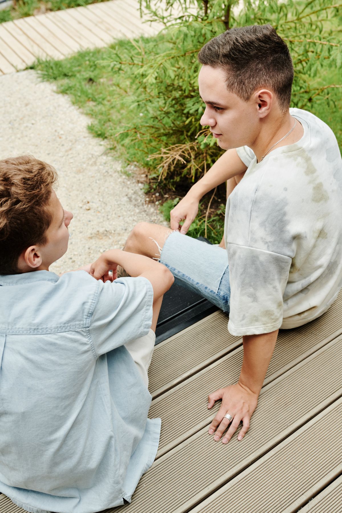 Two young people in a supportive conversation outdoors.